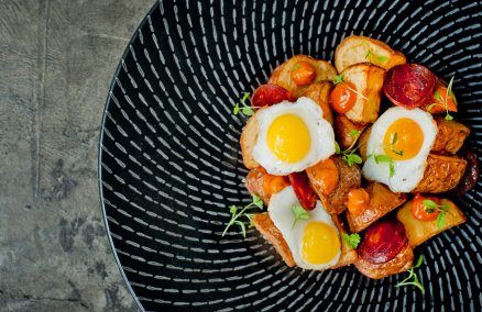 Patatas Bravas with chorizo and fried quail eggs