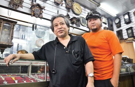 Wanchai and Ratanachai of the antique clock repair shop “Be-Tek-Kuang”