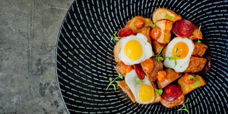 Patatas Bravas with chorizo and fried quail eggs