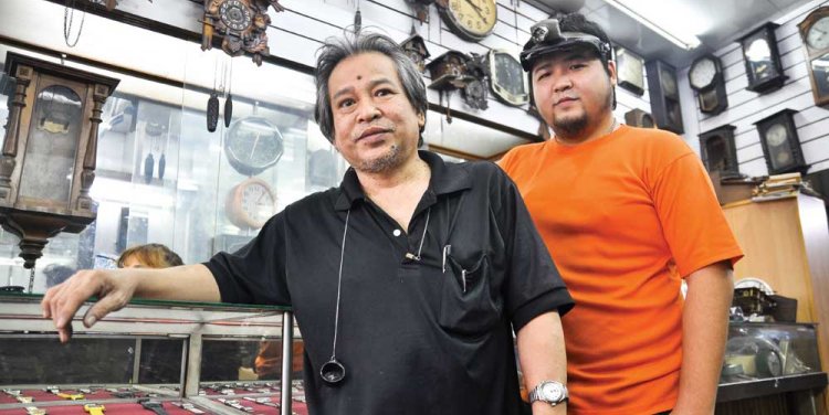 Wanchai and Ratanachai of the antique clock repair shop “Be-Tek-Kuang”