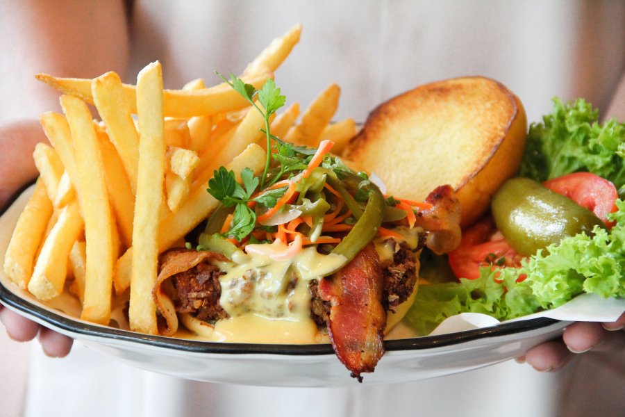 black tap - double bacon cheeseburger, crispy bacon, topped with American cheese, crunchy lettuce, tomato, pickles