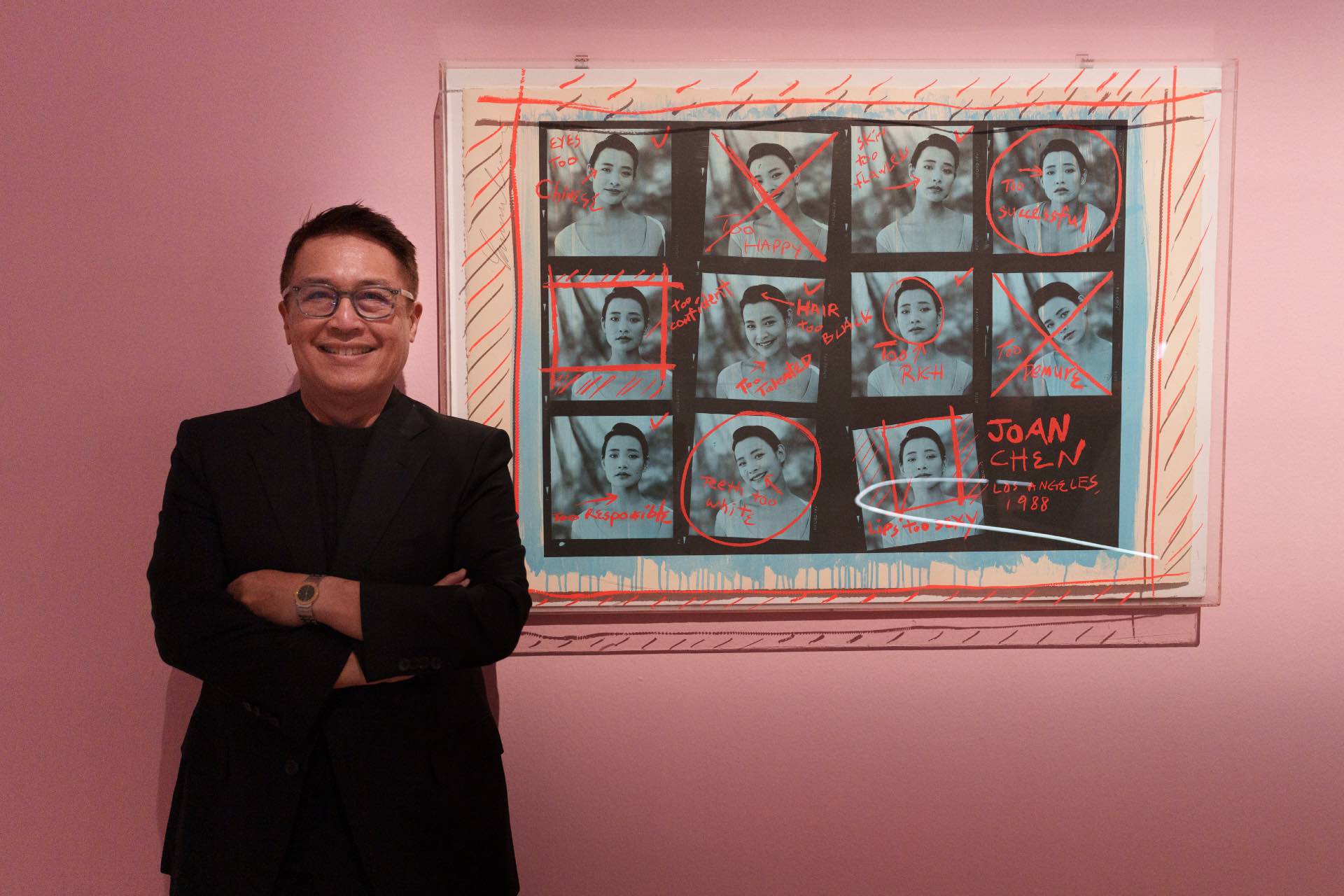 Celebrated Singaporean photographer Russel Wong next to his blue lithograph print of Chinese-American actress Joan Chen