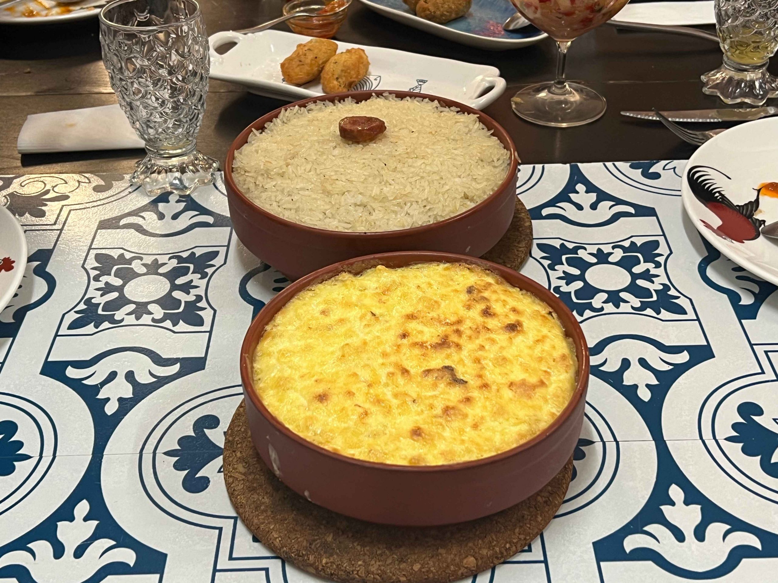 Belos Tempos cod fish with cream (front) and Portguese baked duck rice (back). Photo: Karen Tee